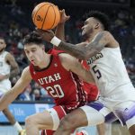 
              Washington's Jamal Bey (5) drives into Utah's Lazar Stefanovic (20) during the second half of an NCAA college basketball game in the first round of the Pac-12 tournament Wednesday, March 9, 2022, in Las Vegas. (AP Photo/John Locher)
            