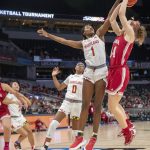 
              Maryland guard Diamond Miller (1) blocks a shot by Indiana guard Grace Berger (34) during an NCAA college basketball game in the Big Ten conference tournament, Friday, March 4, 2022, at Gainbridge Fieldhouse in Indianapolis. (Robert Scheer/The Indianapolis Star via AP)
            