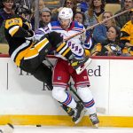 
              New York Rangers' Barclay Goodrow (21) checks Pittsburgh Penguins' Radim Zohorna off the puck during the second period of an NHL hockey game in Pittsburgh, Tuesday, March 29, 2022. (AP Photo/Gene J. Puskar)
            