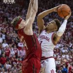 
              Indiana guard Rob Phinisee (1) shoots while being defended by Rutgers guard Paul Mulcahy (4) during the second half of an NCAA college basketball game, Wednesday, March 2, 2022, in Bloomington, Ind. (AP Photo/Doug McSchooler)
            