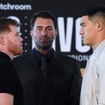 
              Boxer Canelo Alvarez, left, poses with boxer Dmitry Bivol as promoter Eddie Hern, center, looks on, during a weigh-in in advance of their boxing fight Wednesday, March 2, 2022, in San Diego. Alvarez, of Mexico, is scheduled to fight Bivol, of Russia, in Las Vegas on May 7. (AP Photo/Gregory Bull)
            