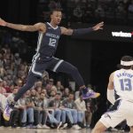 
              Memphis Grizzlies' Ja Morant (12) jumps to block a shot by Orlando Magic's R.J. Hampton (13) in the first half of an NBA basketball game Saturday, March 5, 2022, in Memphis, Tenn. (AP Photo/Karen Pulfer Focht)
            