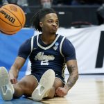 
              Akron guard Greg Tribble (2) sits on the court after goin down during the second half of a first-round NCAA college basketball tournament game against UCLA, Thursday, March 17, 2022, in Portland, Ore. (AP Photo/Craig Mitchelldyer)
            