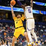 
              Missouri guard Javon Pickett (4) attempts a shot over LSU forward Mwani Wilkinson (5) during the second half of an NCAA men's college basketball game at the Southeastern Conference tournament in Tampa, Fla., Thursday, March 10, 2022. (AP Photo/Chris O'Meara)
            