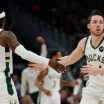 
              Milwaukee Bucks' Pat Connaughton is congratulated by Wesley Matthews after making a shot during the first half of an NBA basketball game Tuesday, Feb. 22, 2022, in Milwaukee . (AP Photo/Morry Gash)
            