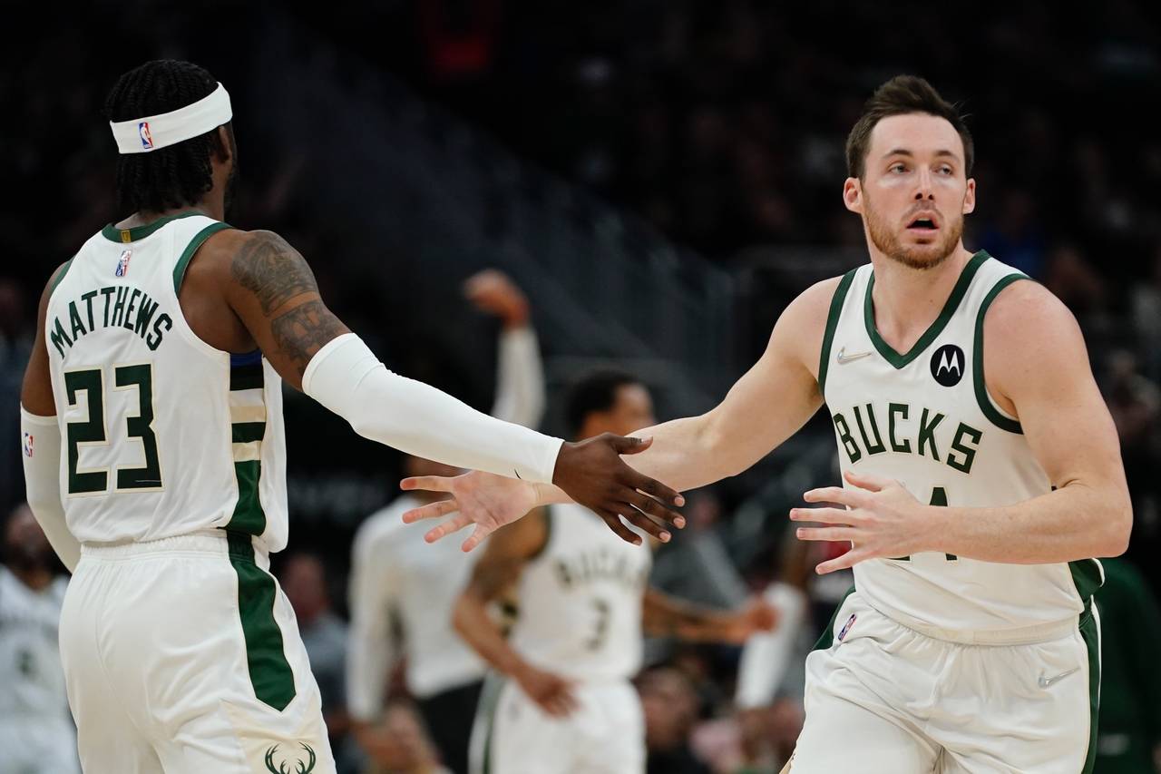 Milwaukee Bucks' Pat Connaughton is congratulated by Wesley Matthews after making a shot during the...