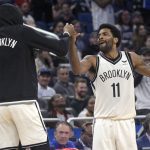 
              Brooklyn Nets guard Kyrie Irving (11) celebrates with forward Kevin Durant, left, after Irving scored his 60th point of the game in the second half of an NBA basketball game against the Orlando Magic, Tuesday, March 15, 2022, in  Orlando, Fla. (AP Photo/Phelan M. Ebenhack)
            