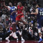 
              Toronto Raptors forward OG Anunoby (3) moves the ball past Minnesota Timberwolves centre Naz Reid, left, as Timberwolves center Karl-Anthony Towns (32) watches during the second half of an NBA basketball game Wednesday, March 30, 2022, in Toronto. (Nathan Denette/The Canadian Press via AP)
            