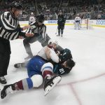
              Referees move in to break up a fight by Colorado Avalanche defenseman Kurtis MacDermid, bottom left, and San Jose Sharks defenseman Jacob Middleton during the first period of an NHL hockey game in San Jose, Calif., Friday, March 18, 2022. (AP Photo/Jeff Chiu)
            
