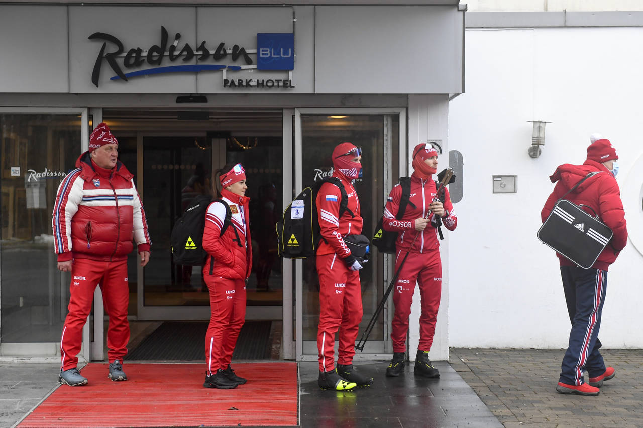 Members of the Russian cross-country ski national team stand outside the Radisson Blu Hotel at Forn...