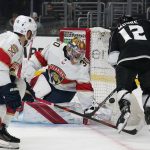 
              Florida Panthers goaltender Spencer Knight (30) stops a shot by Los Angeles Kings center Trevor Moore (12) during the second period of an NHL hockey game Sunday, March 13, 2022, in Los Angeles. (AP Photo/Ashley Landis)
            