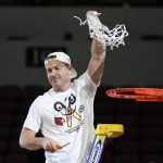 
              Louisville head coach Jeff Walz cuts down a net after beating Michigan 62-50 in a college basketball game in the Elite 8 round of the NCAA women's tournament Monday, March 28, 2022, in Wichita, Kan. (AP Photo/Jeff Roberson)
            