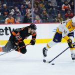 
              Philadelphia Flyers' Claude Giroux, left, and Nashville Predators' Ryan Johansen chase the puck during the second period of an NHL hockey game, Thursday, March 17, 2022, in Philadelphia. (AP Photo/Matt Slocum)
            