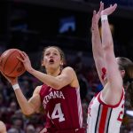 
              Indiana guard Ali Patberg (14) looks to shoot over Ohio State guard Taylor Mikesell, right, in the second half of an NCAA college basketball game at the Big Ten Conference tournament in Indianapolis, Saturday, March 5, 2022. (AP Photo/Michael Conroy)
            