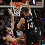 
              Miami Heat guard Tyler Herro (14) aims to score as Philadelphia 76ers guard Furkan Korkmaz (30) defends during the first half of an NBA basketball game, Saturday, March 5, 2022, in Miami. (AP Photo/Marta Lavandier)
            