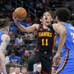
              Atlanta Hawks guard Trae Young (11) prepares to shoot as Oklahoma City Thunder guard Vit Krejci, left, and center Olivier Sarr (30) defend during the first half of an NBA basketball game Wednesday, March 30, 2022, in Oklahoma City. (AP Photo/Nate Billings)
            