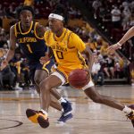 
              Arizona State guard DJ Horne (0) drives as California guard Joel Brown (1) defends during the second half of an NCAA college basketball game, Thursday, March 3, 2022, in Tempe, Ariz. (AP Photo/Matt York)
            