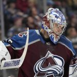 
              Colorado Avalanche goaltender Darcy Kuemper checks his glove during a timeout in the second period of the team's NHL hockey game against the New York Islanders on Tuesday, March 1, 2022, in Denver. (AP Photo/David Zalubowski)
            