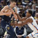 
              Oklahoma City Thunder guard Theo Maledon, right, tries to steal the ball from Denver Nuggets center Nikola Jokic in the first half of an NBA basketball game Saturday, March 26, 2022, in Denver. (AP Photo/David Zalubowski)
            