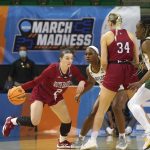 
              South Dakota guard Liv Korngable (2) uses a screen from teammate center Hannah Sjerven (34) against Baylor guard Jordan Lewis (3) and center Queen Egbo (4) during the first half of a college basketball game in the second round of the NCAA tournament in Waco, Texas, Sunday, March 20, 2022. (AP Photo/LM Otero)
            