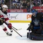 
              Toronto Maple Leafs goaltender Petr Mrazek (35) makes a save as New Jersey Devils left wing A.J. Greer (42) looks for a rebound during the first period of an NHL hockey game Wednesday, March 23, 2022, in Toronto. (Frank Gunn/The Canadian Press via AP)
            