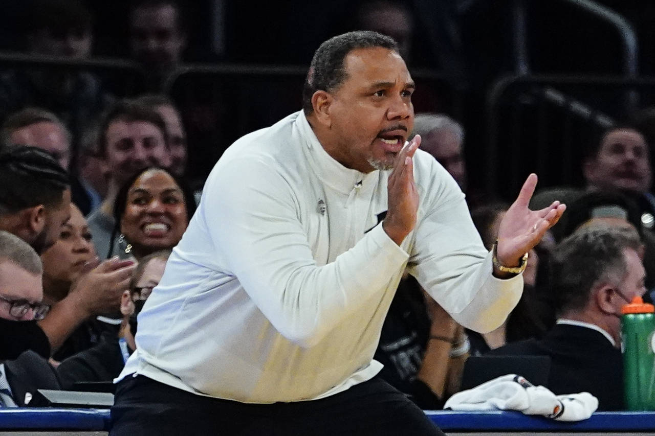 Providence head coach Ed Cooley claps for his players during the first half of an NCAA college bask...