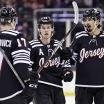 
              New Jersey Devils center Jack Hughes (86) is congratulated by teammates after scoring his second goal of the third period against the New York Rangers during an NHL hockey game on Tuesday, March 22, 2022, in Newark, N.J. The Devils won 7-4. (AP Photo/Adam Hunger)
            