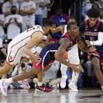 
              Arizona guard Bennedict Mathurin, center, collides with guard Justin Kier (5) after stealing the ball from Southern California forward Isaiah Mobley, left, during the first half of an NCAA college basketball game Tuesday, March 1, 2022, in Los Angeles. (AP Photo/Marcio Jose Sanchez)
            