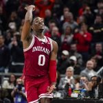 
              Indiana guard Xavier Johnson (0) celebrates following an NCAA college basketball game against Illinois at the Big Ten Conference tournament in Indianapolis, Friday, March 11, 2022. Indiana defeated Illinois 65-63.(AP Photo/Michael Conroy)
            