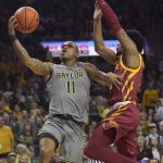 
              Baylor guard James Akinjo (11) drives against Iowa State guard Tyrese Hunter (11) during the first half of an NCAA college basketball game in Waco, Texas, Saturday, March 5, 2022. (AP Photo/LM Otero)
            