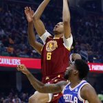 
              Cleveland Cavaliers' Moses Brown goes up for a dunk against Philadelphia 76ers' Shake Milton (18) during the first half of an NBA basketball game Wednesday, March 16, 2022, in Cleveland. (AP Photo/Ron Schwane)
            