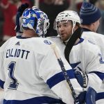 
              Tampa Bay Lightning goaltender Brian Elliott (1) and Brayden Point celebrate after beating the Detroit Red Wings 2-1 in overtime during an NHL hockey game Saturday, March 26, 2022, in Detroit. (AP Photo/Paul Sancya)
            