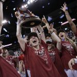 
              Stanford players celebrate with the regional trophy after they beat Texas 59-50 in a college basketball game in the Elite 8 round of the NCAA tournament, Sunday, March 27, 2022, in Spokane, Wash. Stanford won 59-50. (AP Photo/Young Kwak)
            