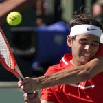 
              Taylor Fritz returns a shot to Miomir Kecmanovic, of Serbia, during the men's singles quarterfinals at the BNP Paribas Open tennis tournament Friday, March 18, 2022, in Indian Wells, Calif. (AP Photo/Mark J. Terrill)
            