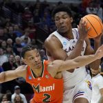 
              Kansas' David McCormack tries to get past Miami's Isaiah Wong during the second half of a college basketball game in the Elite 8 round of the NCAA tournament Sunday, March 27, 2022, in Chicago. (AP Photo/Nam Y. Huh)
            