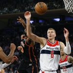 
              Washington Wizards' Kristaps Porzingis (6) goes for a rebound against New York Knicks' Mitchell Robinson (23) during the fourth quarter of an NBA basketball game Friday, March 18, 2022, in New York. (AP Photo/Jason DeCrow)
            