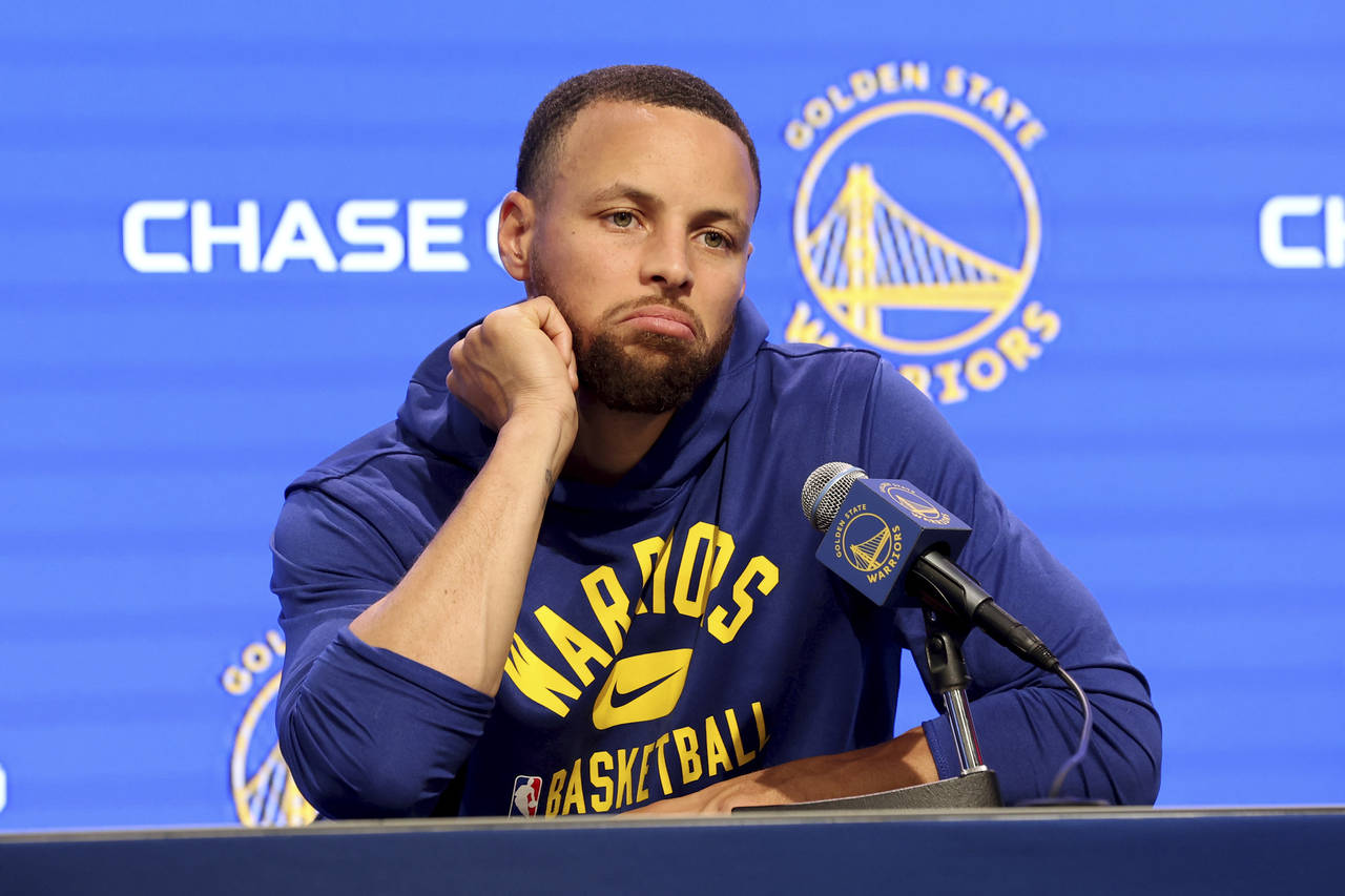 Golden State Warriors guard Stephen Curry talks to the media about his injury before an NBA basketb...