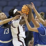 
              South Carolina forward Laeticia Amihere (15) is pressured by Creighton guard Rachael Saunders (13), guard Tatum Rembao (2) and guard Morgan Maly, rear, during the first half of a college basketball game in the Elite 8 round of the NCAA tournament in Greensboro, N.C., Sunday, March 27, 2022. (AP Photo/Gerry Broome)
            