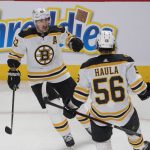 
              Boston Bruins' Brad Marchand (63) celebrates with teammate Erik Haula (56) after scoring the winning goal during overtime of an NHL hockey game against the Montreal Canadiens in Montreal, Monday, March 21, 2022. (Ryan Remiorz/The Canadian Press via AP)
            