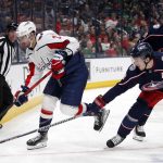 
              Washington Capitals defenseman Justin Schultz, left, chases the puck in front of Columbus Blue Jackets defenseman Zach Werenski, center, and forward Eric Robinson during the first period of an NHL hockey game in Columbus, Ohio, Thursday, March 17, 2022. (AP Photo/Paul Vernon)
            