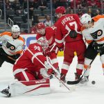 
              Detroit Red Wings goaltender Alex Nedeljkovic (39) stops a Philadelphia Flyers right wing Travis Konecny (11) shot in the third period of an NHL hockey game Tuesday, March 22, 2022, in Detroit. (AP Photo/Paul Sancya)
            