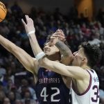 
              Saint Mary's Dan Fotu (42) shoots around Gonzaga's Chet Holmgren (34) during the second half of an NCAA college basketball championship game at the West Coast Conference tournament Tuesday, March 8, 2022, in Las Vegas. (AP Photo/John Locher)
            