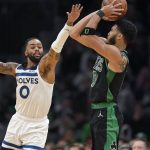 
              Minnesota Timberwolves guard D'Angelo Russell (0) tries to block Boston Celtics forward Jayson Tatum (0) who takes a shot at the basket in the second half of an NBA basketball game, Sunday, March 27, 2022, in Boston. The Celtics won 134-112. (AP Photo/Steven Senne)
            