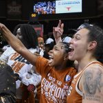 
              Texas guard Aliyah Matharu, holding phone, and teammate Audrey Warren, right, take selfies while celebrating their Big 12 championship over Baylor in an NCAA basketball game in Kansas City, Mo., Sunday, March 13, 2022. (AP Photo/Reed Hoffmann)
            