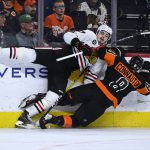 
              Philadelphia Flyers' Kevin Connauton (8) and Chicago Blackhawks' Kirby Dach collide along the boards during the third period of an NHL hockey game, Saturday, March 5, 2022, in Philadelphia. (AP Photo/Derik Hamilton)
            