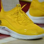 
              The words "No War" are written on the shoes of Maryland forward Pavlo Dziuba, who was born in Kyiv, Ukraine, as he stands for the United States national anthem prior to an NCAA college basketball game against Ohio State, Feb. 27, 2022, in College Park, Md. (AP Photo/Julio Cortez)
            
