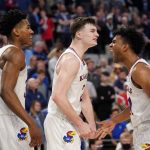 
              Kansas's Ochai Agbaji (30), Christian Braun (2) and Remy Martin, right, celebrate in the closing seconds of their second-round game against Creighton in the NCAA college basketball tournament in Fort Worth, Texas, Saturday, March, 19, 2022. (AP Photo/Tony Gutierrez)
            