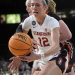 
              Stanford guard Lexie Hull (12) grabs a loose ball against Oregon State during an NCAA college basketball game in the quarterfinals of the Pac-12 women's tournament Thursday, March 3, 2022, in Las Vegas. (AP Photo/David Becker)
            