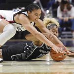
              Connecticut's Azzi Fudd, top and Georgetown's Kaylin West, bottom reach for the ball during the first half of an NCAA college basketball game in the quarterfinals of the Big East Conference tournament at Mohegan Sun Arena, Saturday, March 5, 2022, in Uncasville, Conn. (AP Photo/Jessica Hill)
            