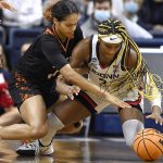 
              Mercer's Nigeria Harkless, left, and Connecticut's Aaliyah Edwards reach for the ball during the first half of a first-round women's college basketball game in the NCAA tournament, Saturday, March 19, 2022, in Storrs, Conn. (AP Photo/Jessica Hill)
            